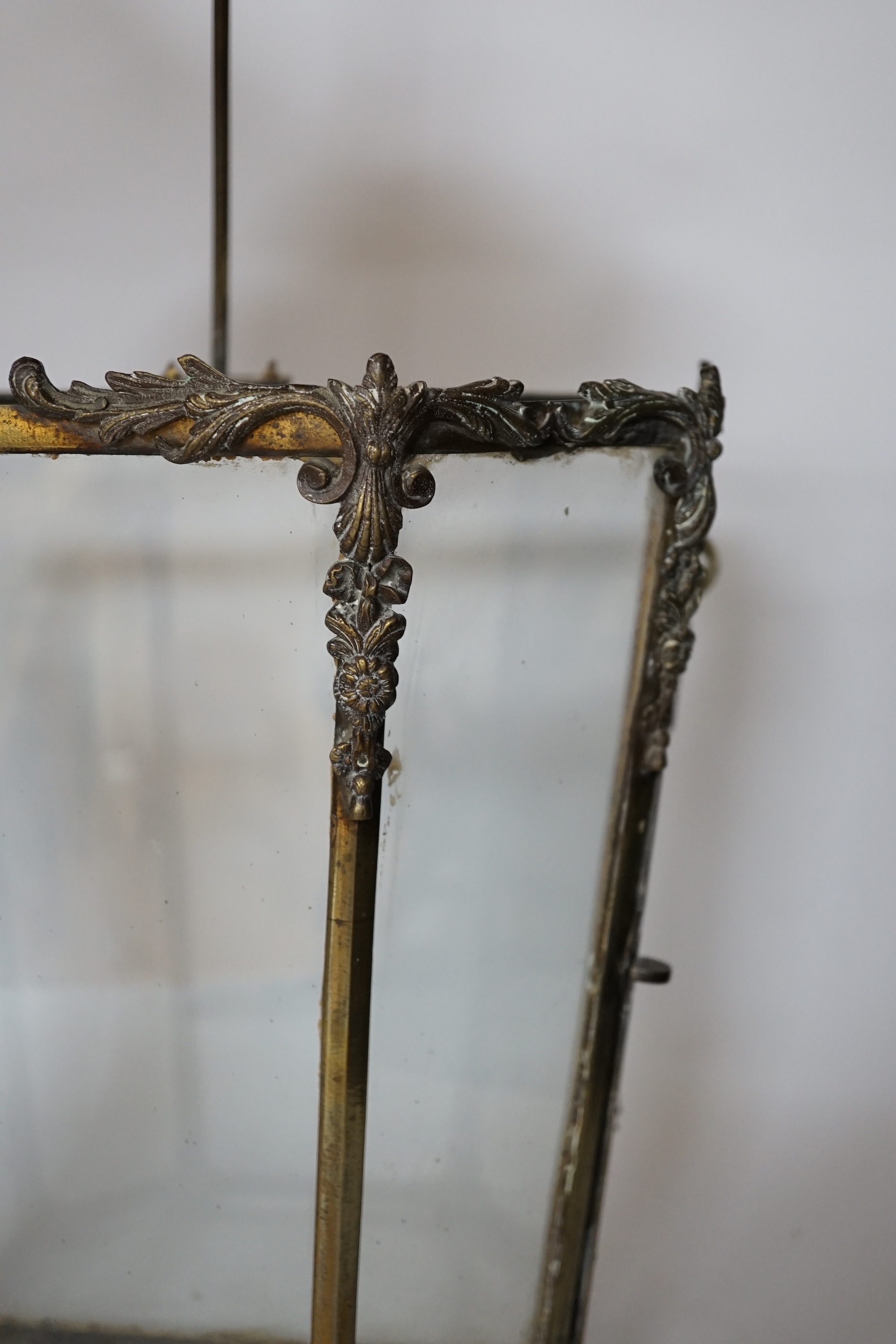 A 19th century brass framed porch lamp with applied scrolled decoration, 65cm high
